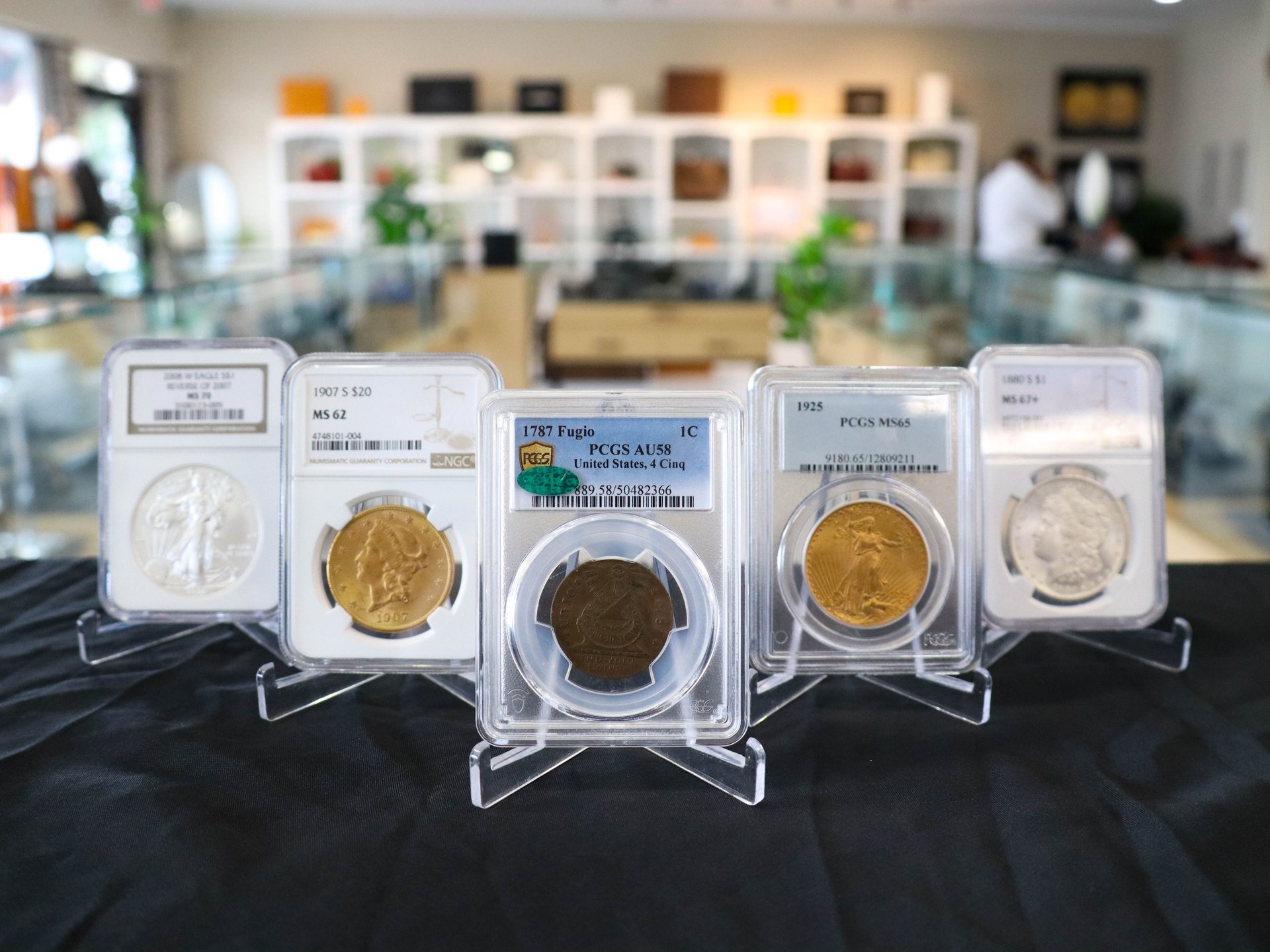 Slabbed rare coins on the counter of The Vault & Co. showroom